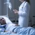 Nurse helping dying woman